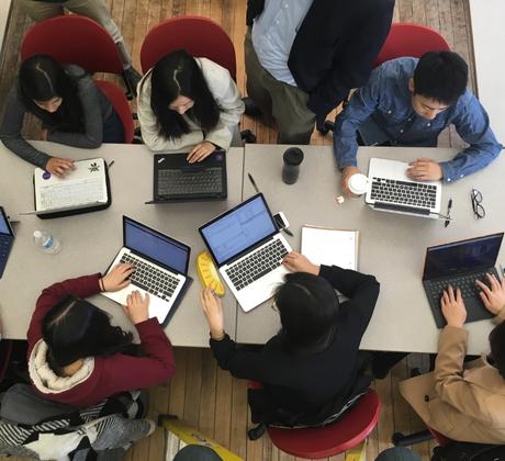 A group of students working on laptops. Journalism Values, Practice and Trends